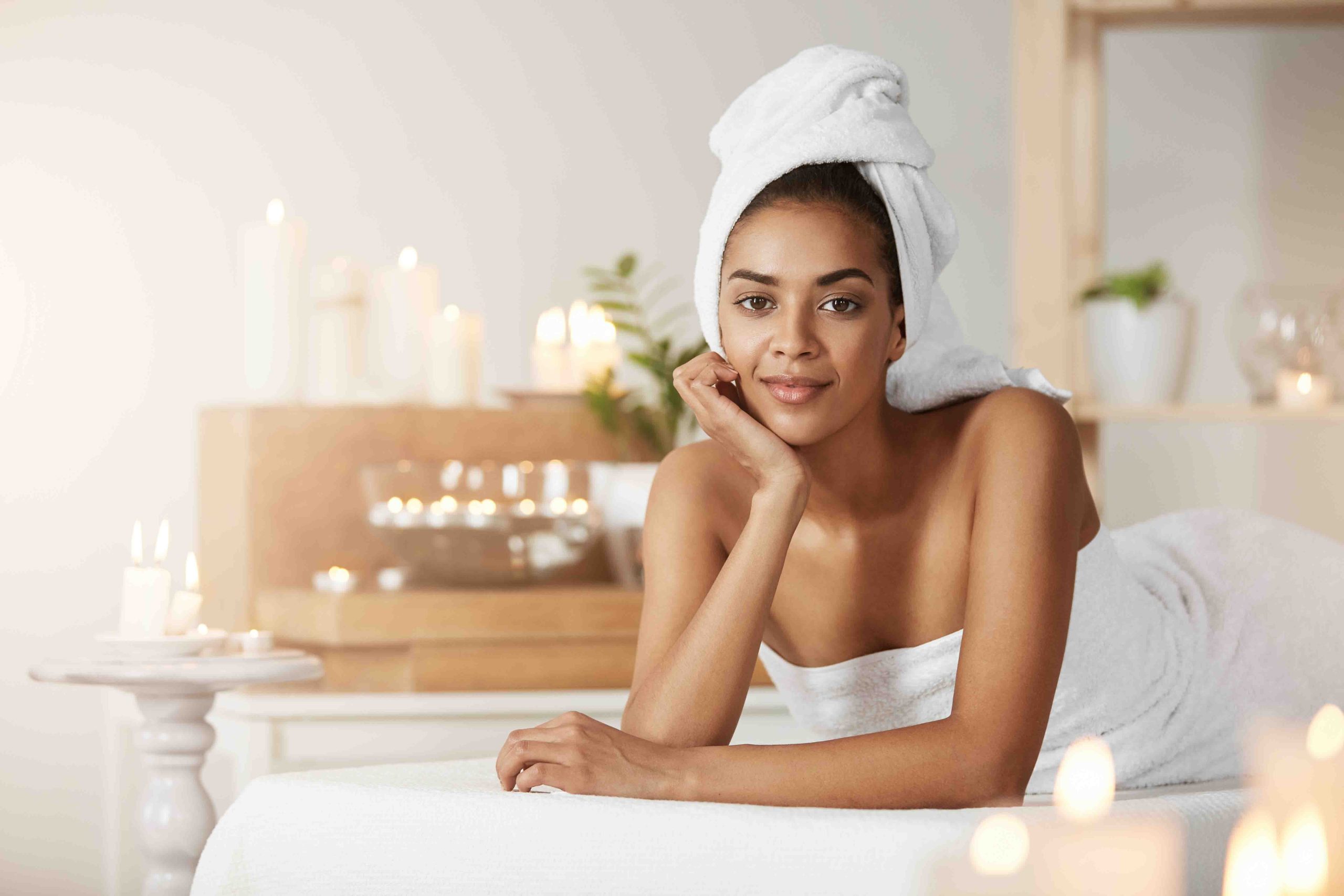 portrait beautiful african woman with towel head smiling resting spa salon scaled
